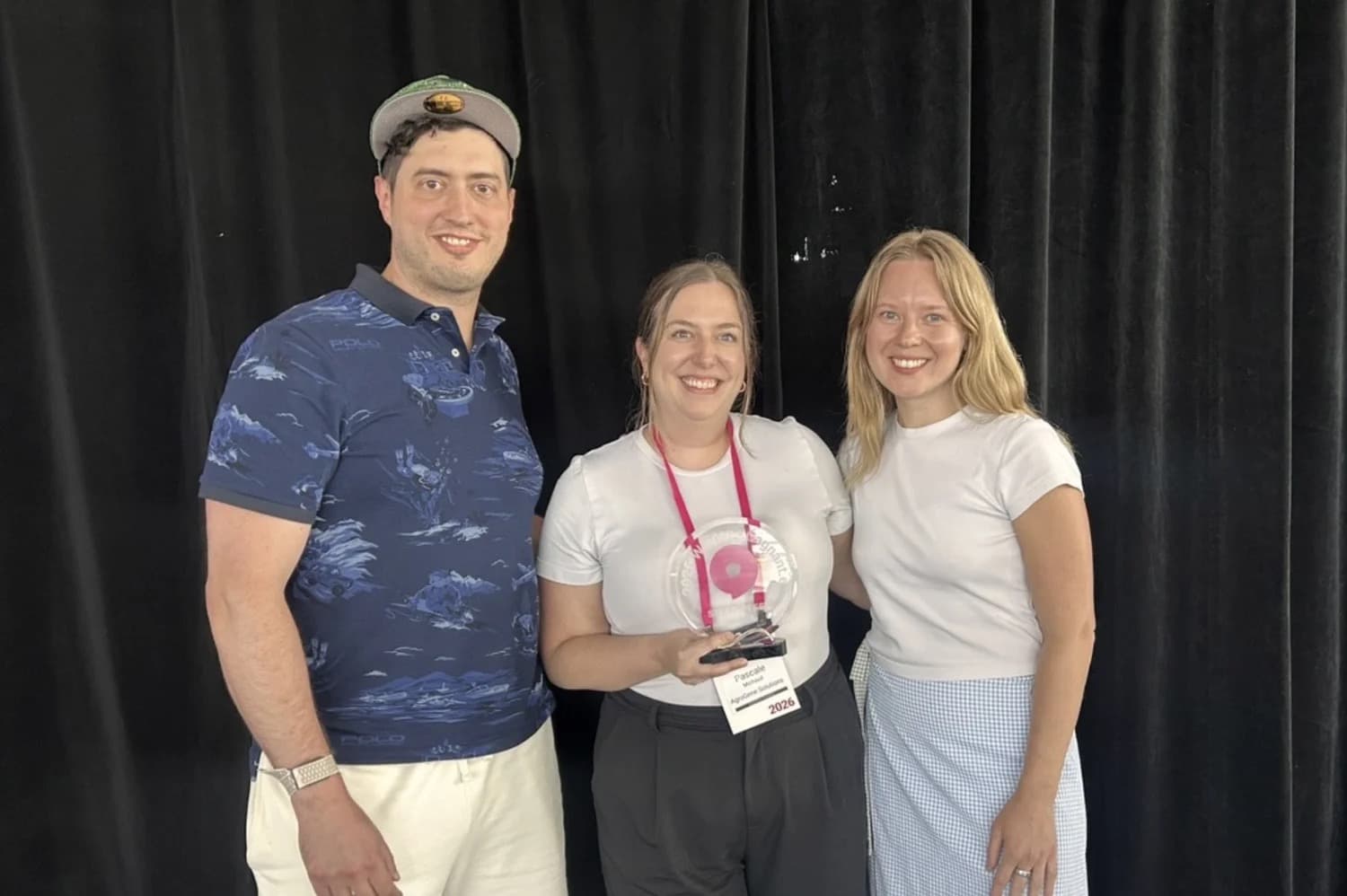 Three members of the AgroGene team smiling with the Startupfest award trophy